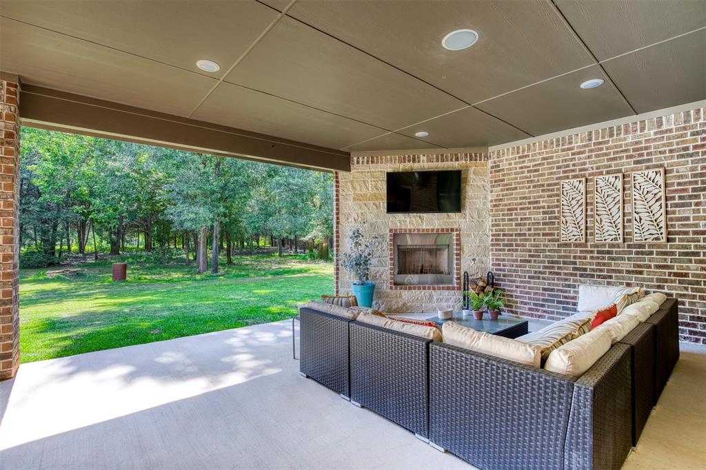 2121 Canyon Lake Road Wills Point, TX 75169 - Photo 29 of 40 a backyard of a house with fountain table and chairs