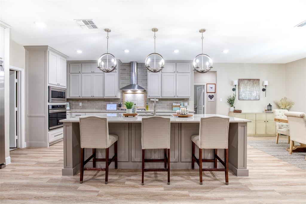 2121 Canyon Lake Road Wills Point, TX 75169 - Photo 4 of 40 a kitchen with a dining table chairs and wooden floor