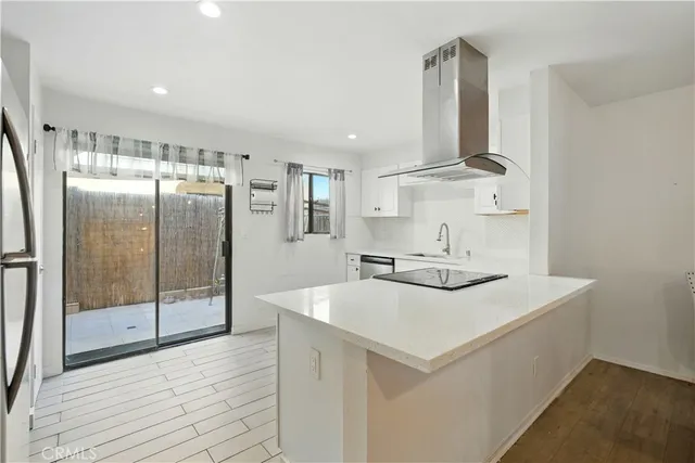 a kitchen with a stove a refrigerator and a sink