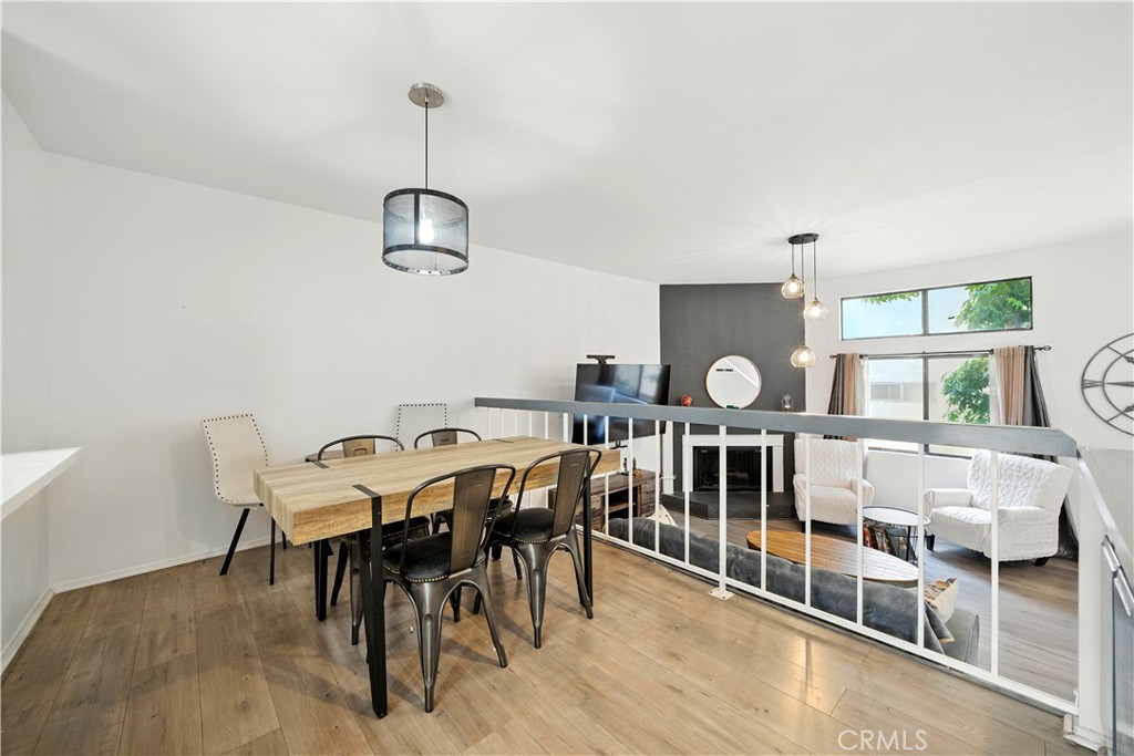 14937 Sherman Way, Unit 7 Van Nuys, CA 91405 - Photo 15 of 37 a view of a dining room with furniture a chandelier and wooden floor