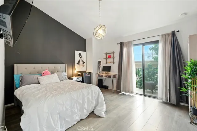 a bed room with a bed window and a flat tv screen