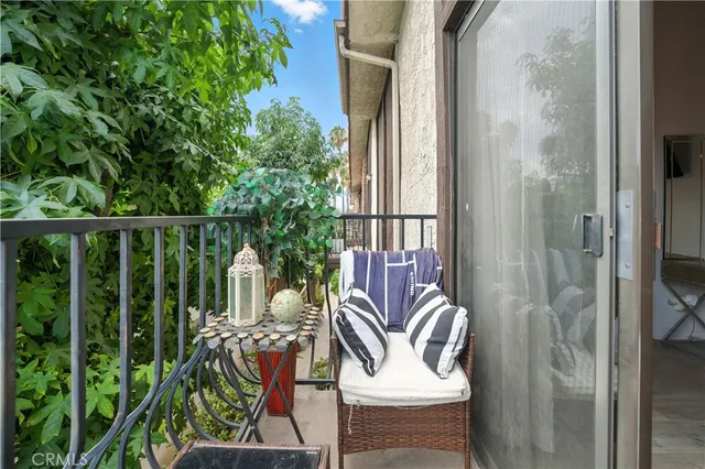 a balcony with table and chairs