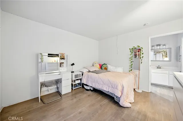 a bedroom with a bed and a desk