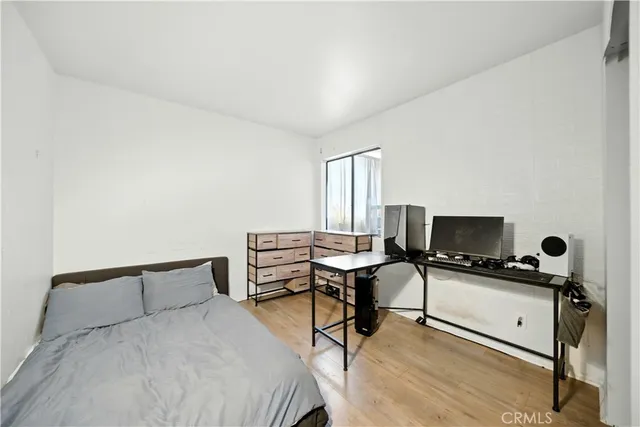 a bedroom with a bed and a desk