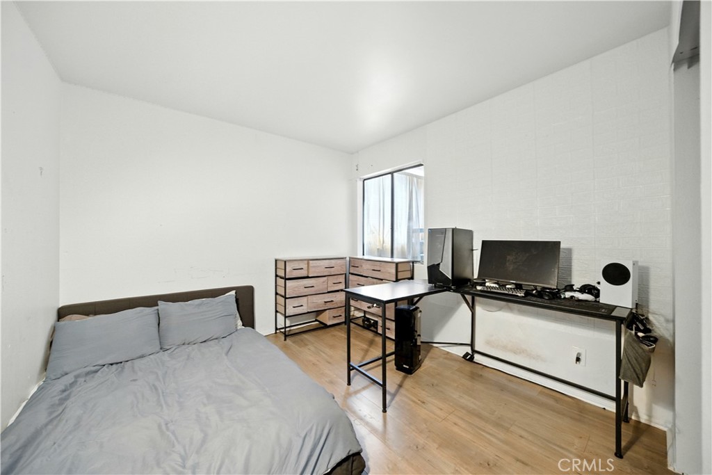 14937 Sherman Way, Unit 7 Van Nuys, CA 91405 - Photo 25 of 37 a bedroom with a bed and a desk