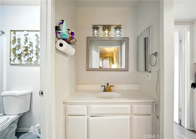 a bathroom with a sink mirror and toilet