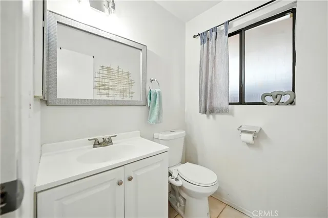 a bathroom with a sink toilet and mirror