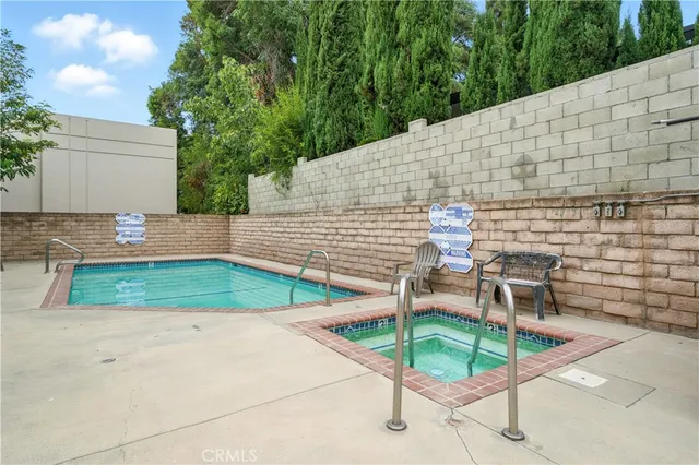 a view of a patio with table and chairs with wooden fence
