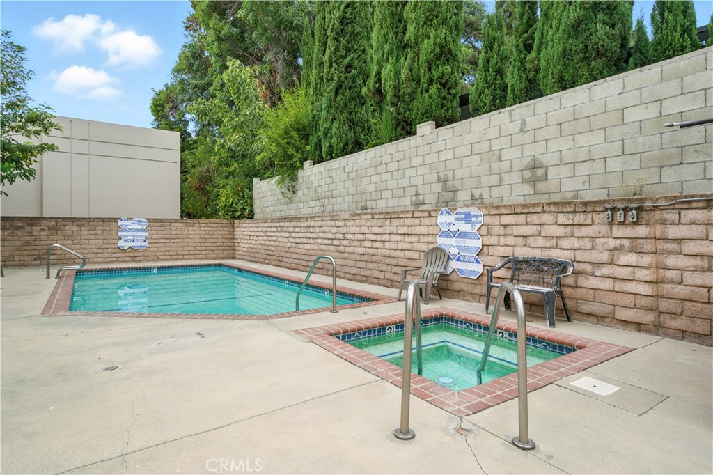 14937 Sherman Way, Unit 7 Van Nuys, CA 91405 - Photo 34 of 37 a view of a patio with table and chairs with wooden fence
