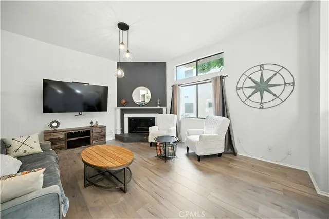 a living room with furniture a flat screen tv and a fireplace