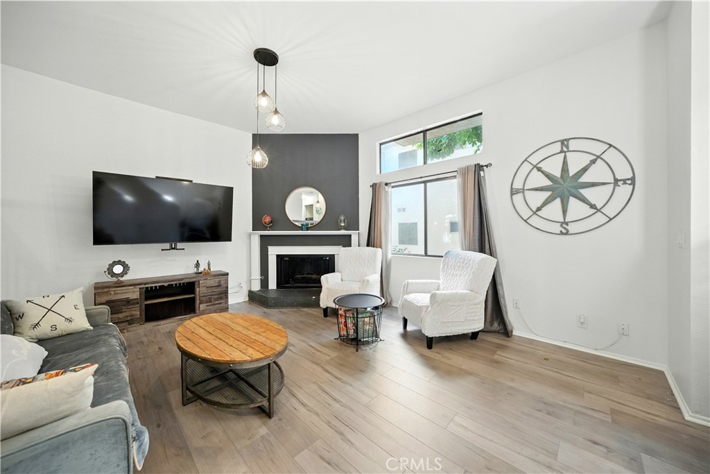 14937 Sherman Way, Unit 7 Van Nuys, CA 91405 - Photo 4 of 37 a living room with furniture a flat screen tv and a fireplace
