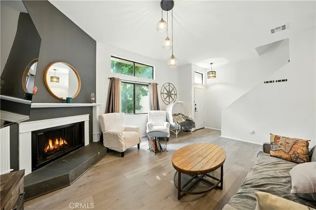 a living room with furniture a window and a fireplace