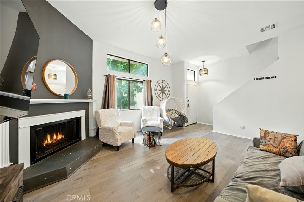 14937 Sherman Way, Unit 7 Van Nuys, CA 91405 - Photo 5 of 37 a living room with furniture a window and a fireplace