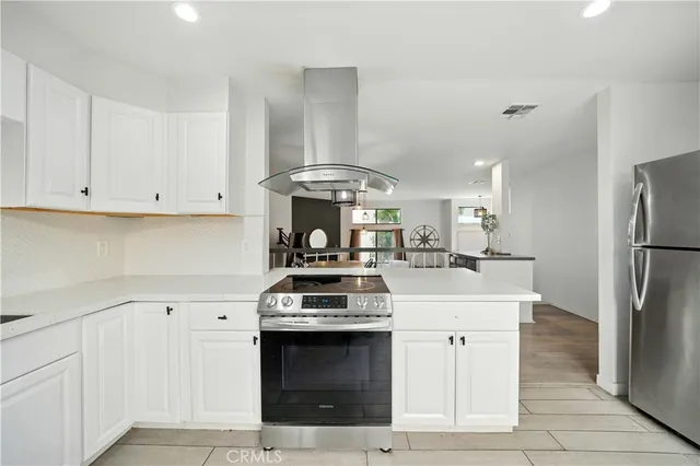 a kitchen with a stove and a refrigerator