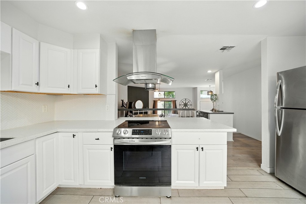 14937 Sherman Way, Unit 7 Van Nuys, CA 91405 - Photo 8 of 37 a kitchen with a stove and a refrigerator