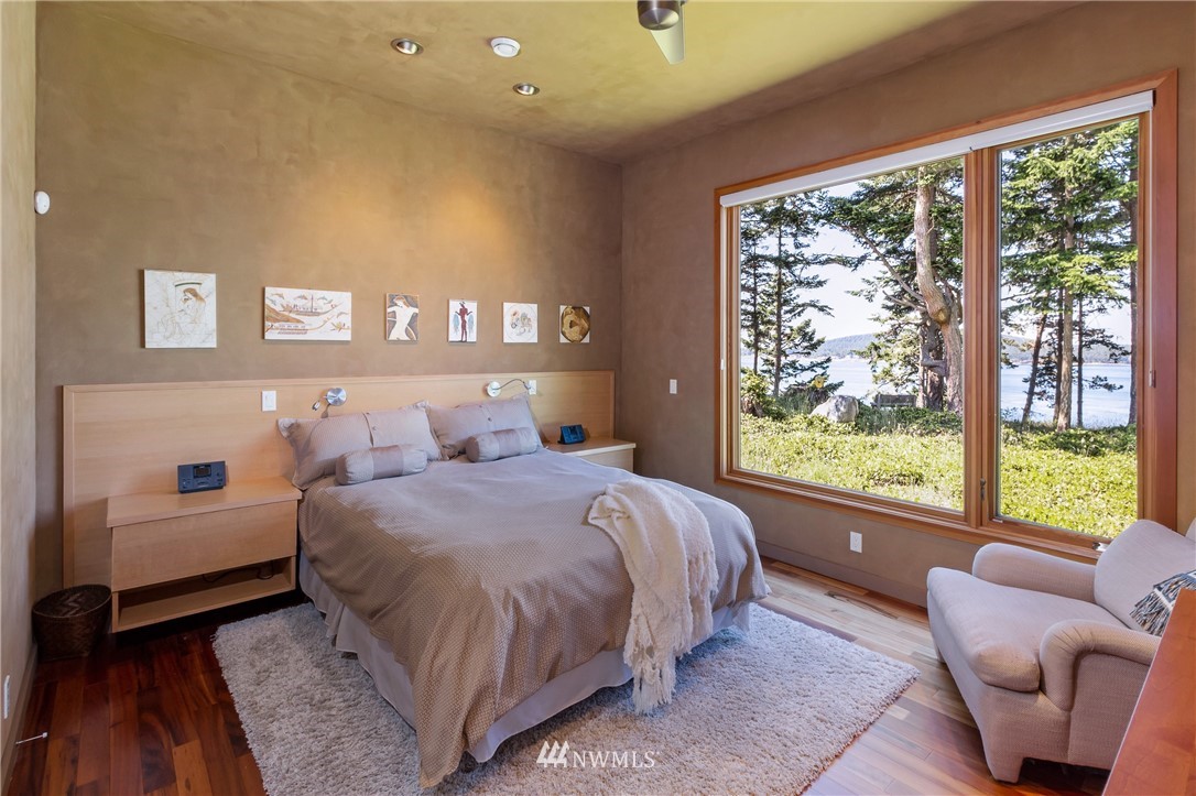 1224 Shark Reef Road Lopez Island, WA 98261 - Photo 13 of 34 a bedroom with a bed and a large window