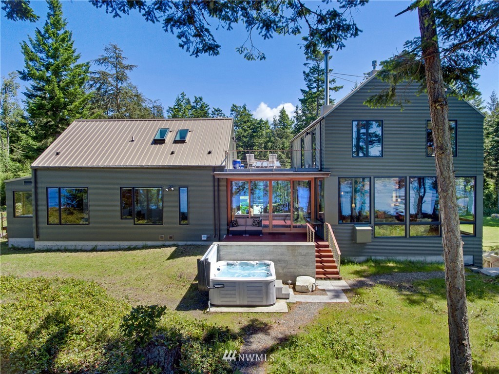 1224 Shark Reef Road Lopez Island, WA 98261 - Photo 29 of 34 a front view of house with yard and trees in the background
