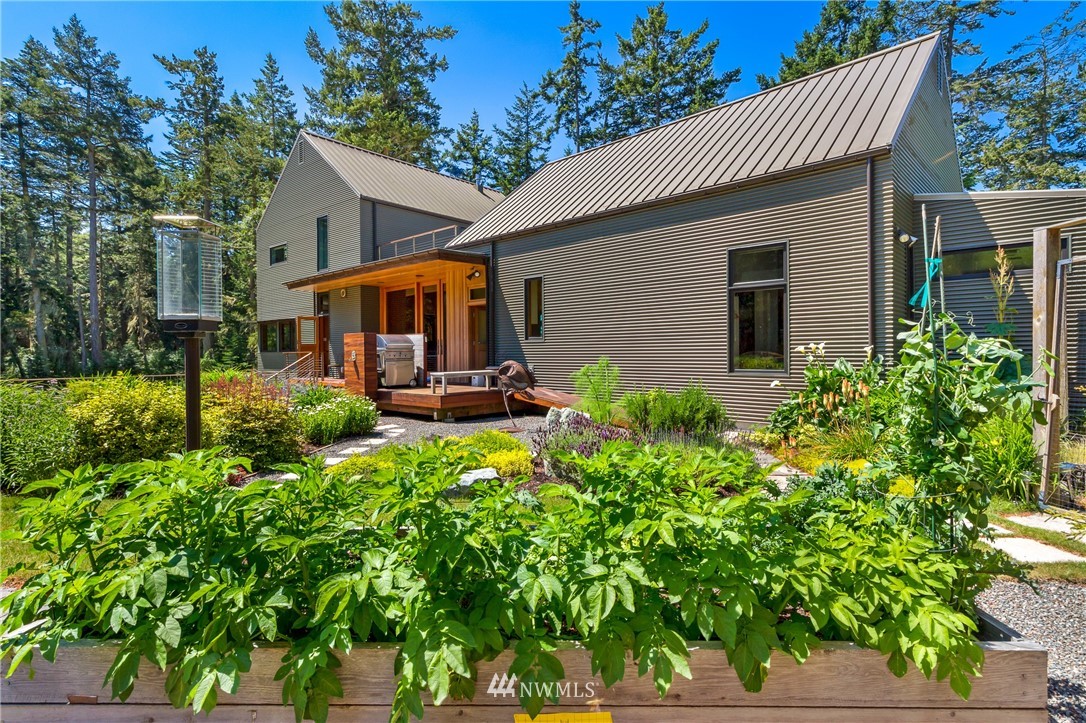 1224 Shark Reef Road Lopez Island, WA 98261 - Photo 7 of 34 a front view of a house with garden