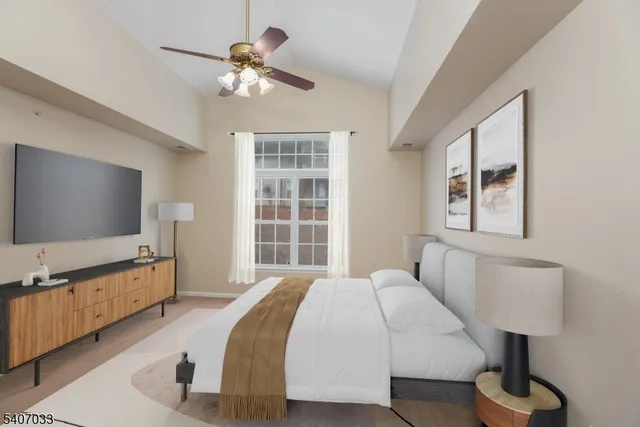 a spacious bedroom with a bed and a flat screen tv