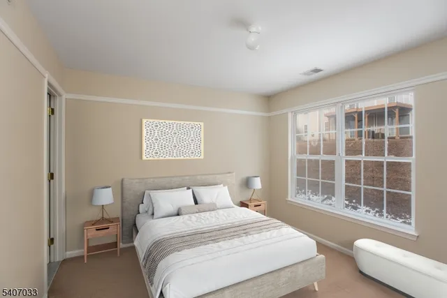 a bedroom with a bed and glass window