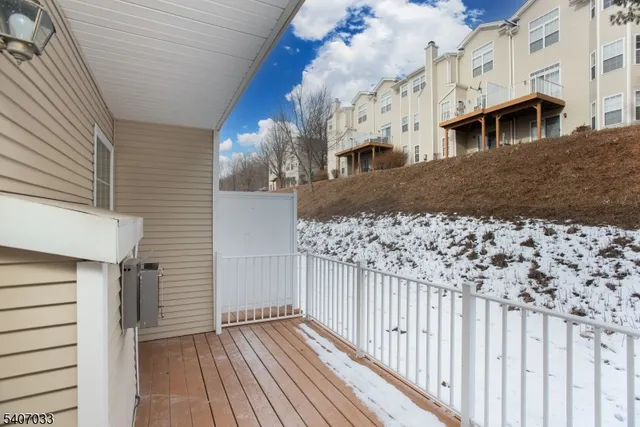 a view of a house with wooden fence
