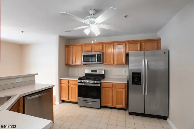 a kitchen with stainless steel appliances granite countertop a stove a refrigerator and a sink