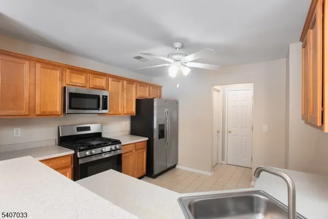 a kitchen with stainless steel appliances a stove a sink and a microwave