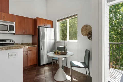 a kitchen with a refrigerator and windows