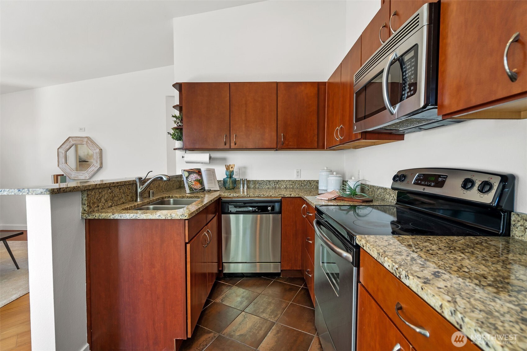 1125 North 93rd Street, Unit 6 Seattle, WA 98103 - Photo 16 of 35 a kitchen with granite countertop a sink a stove and cabinets