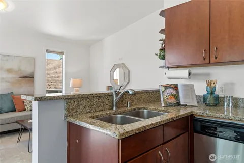 a kitchen with granite countertop a sink and a stove