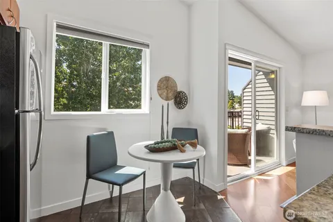 a view of a dining room with furniture window and outside view