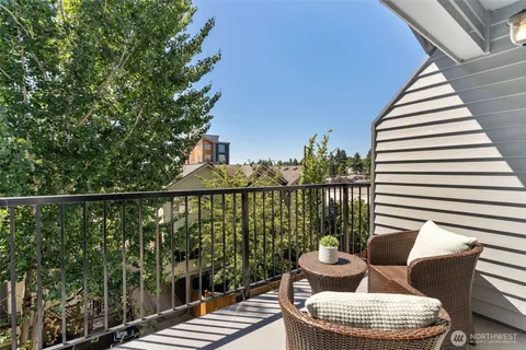 a balcony with furniture and wooden floor