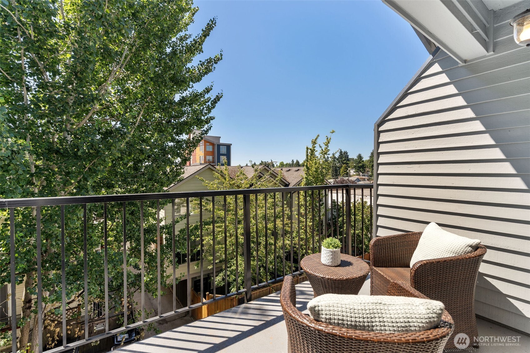 1125 North 93rd Street, Unit 6 Seattle, WA 98103 - Photo 20 of 35 a balcony with furniture and wooden floor
