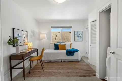 a bedroom with a bed and a lamp next to a window