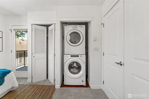 a bathroom with a granite countertop sink mirror vanity and toilet
