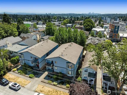 an aerial view of a house with a garden and lake view