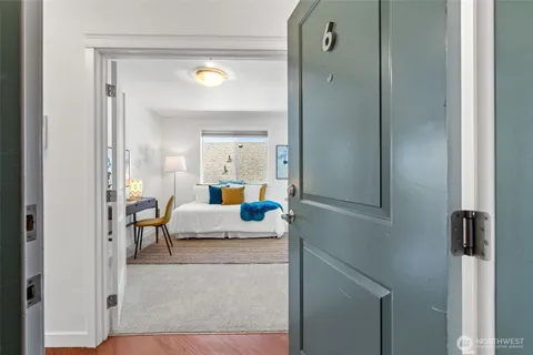 a living room with furniture and a mirror