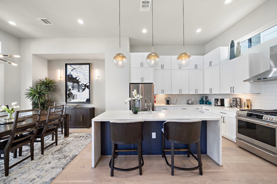 3515 Hutchins Street Houston, TX 77004 - Photo 13 of 35 a kitchen with kitchen island stainless steel appliances a sink a stove a table and chairs