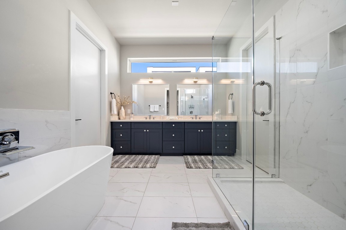 3515 Hutchins Street Houston, TX 77004 - Photo 23 of 35 a bathroom with a tub a double vanity sink and a mirror