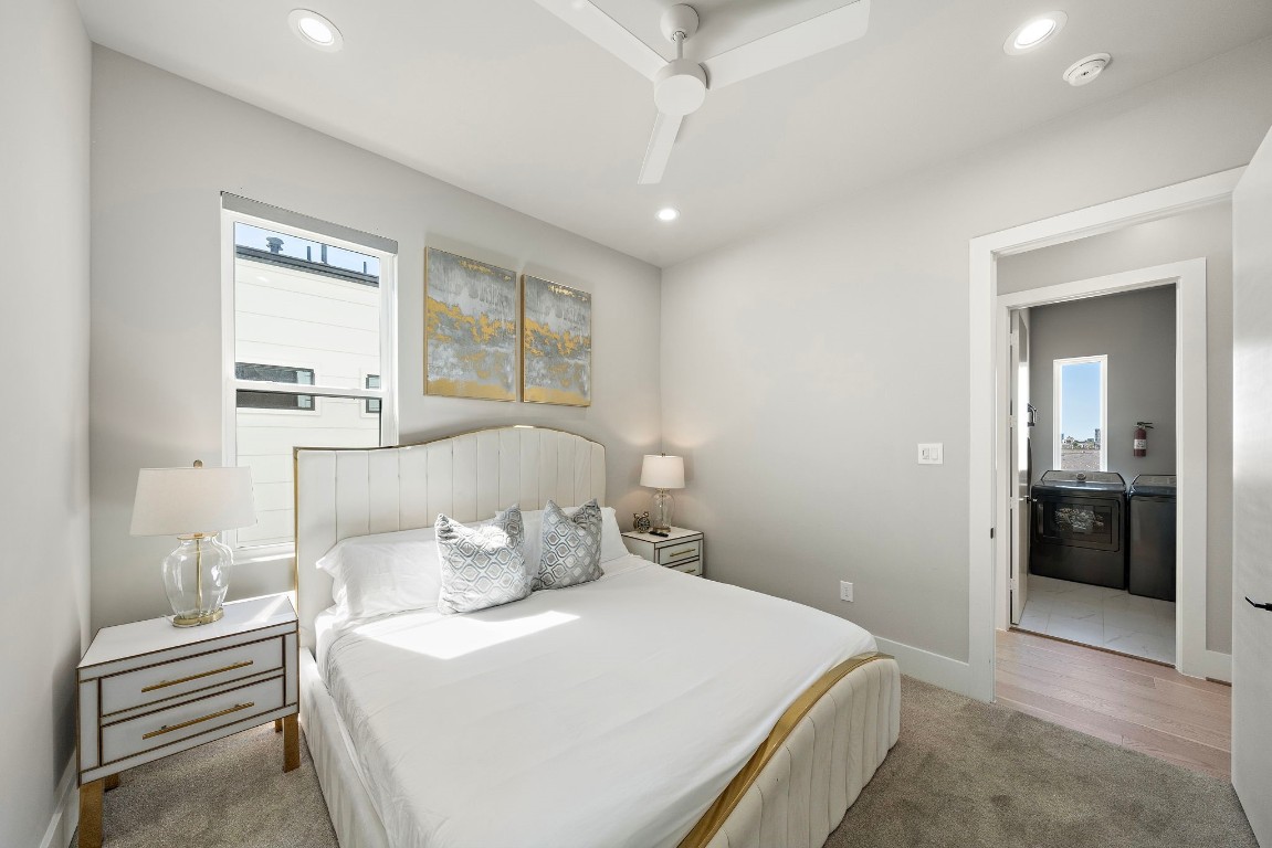 3515 Hutchins Street Houston, TX 77004 - Photo 27 of 35 a bedroom with a large bed and a chandelier