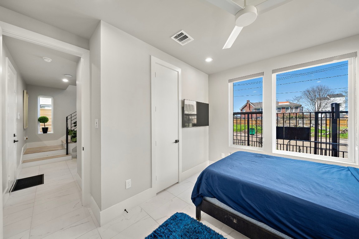 3515 Hutchins Street Houston, TX 77004 - Photo 31 of 35 a spacious bedroom with a bed and glass door