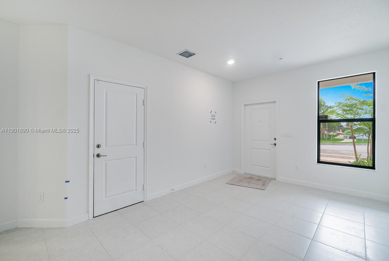 207 Southwest 159th Terrace Pembroke Pines, FL 33027 - Photo 17 of 37 a view of an empty room with a window