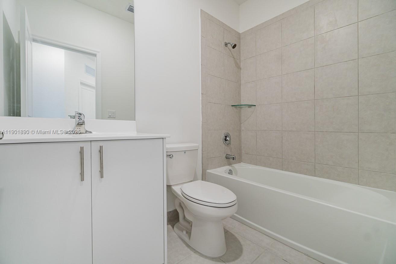 207 Southwest 159th Terrace Pembroke Pines, FL 33027 - Photo 31 of 37 a bathroom with a granite countertop toilet a sink and bathtub