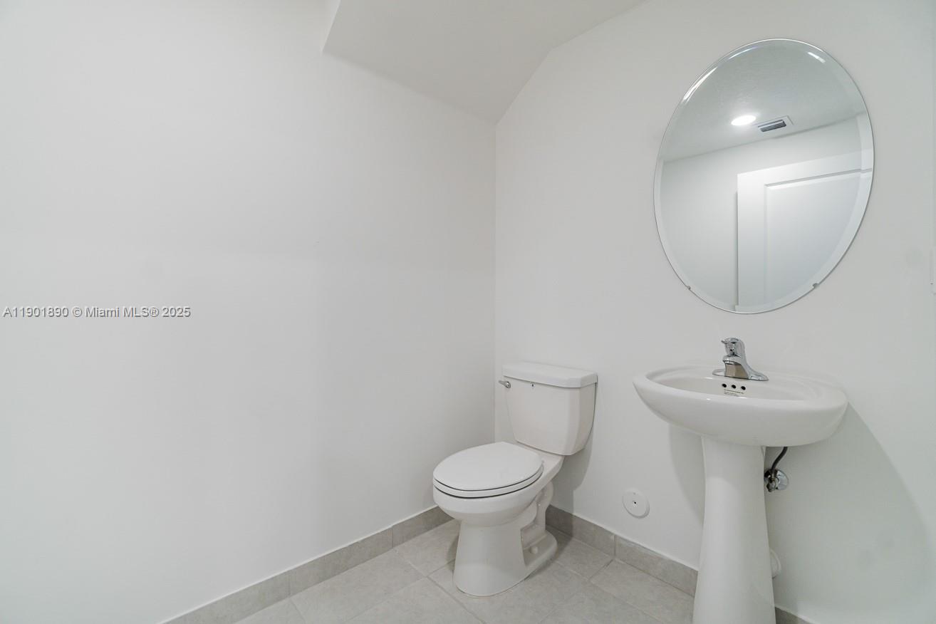 207 Southwest 159th Terrace Pembroke Pines, FL 33027 - Photo 32 of 37 a bathroom with a toilet sink and mirror