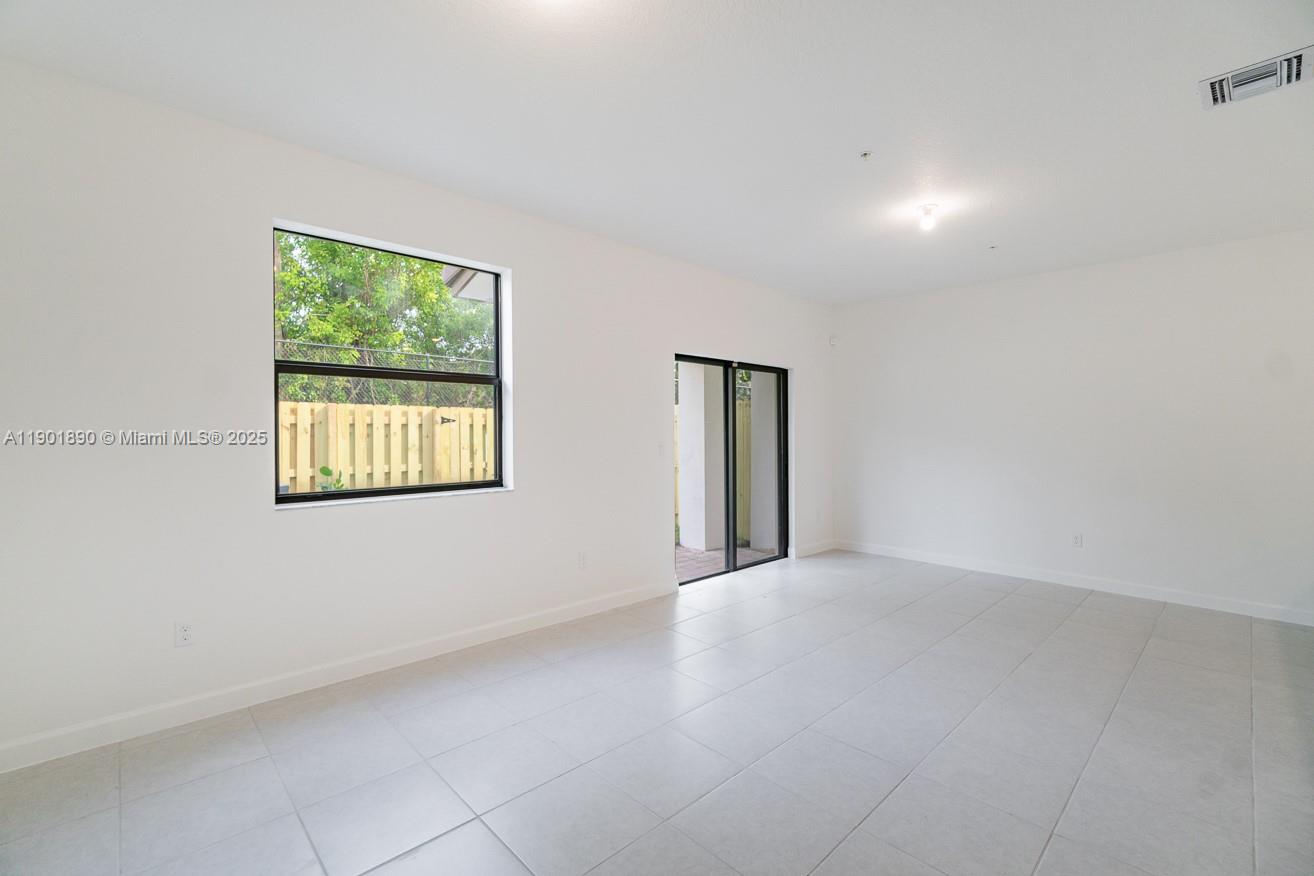 207 Southwest 159th Terrace Pembroke Pines, FL 33027 - Photo 8 of 37 a view of an empty room with a window