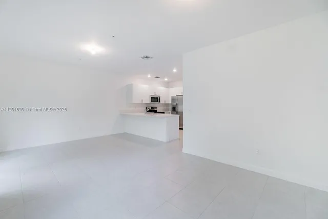 a view of a kitchen with a sink and cabinets