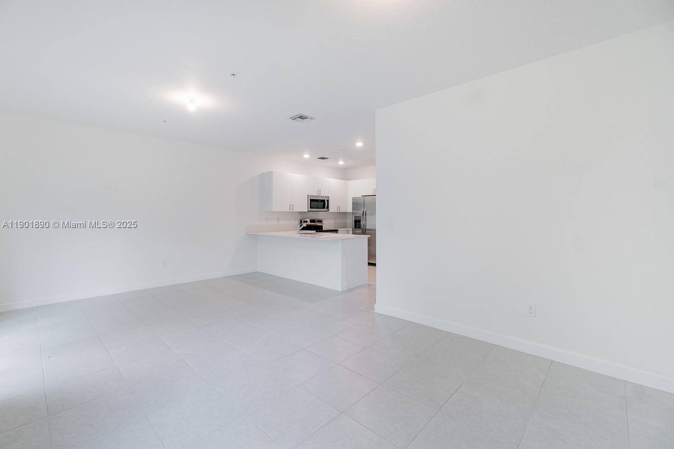 207 Southwest 159th Terrace Pembroke Pines, FL 33027 - Photo 9 of 37 a view of a kitchen with a sink and cabinets