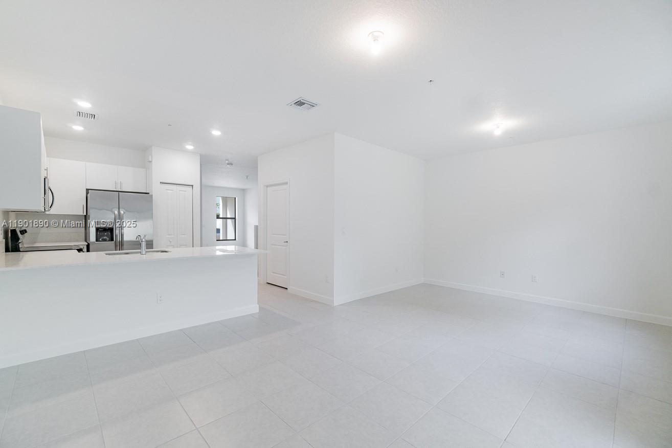 207 Southwest 159th Terrace Pembroke Pines, FL 33027 - Photo 10 of 37 a view of kitchen with refrigerator and window