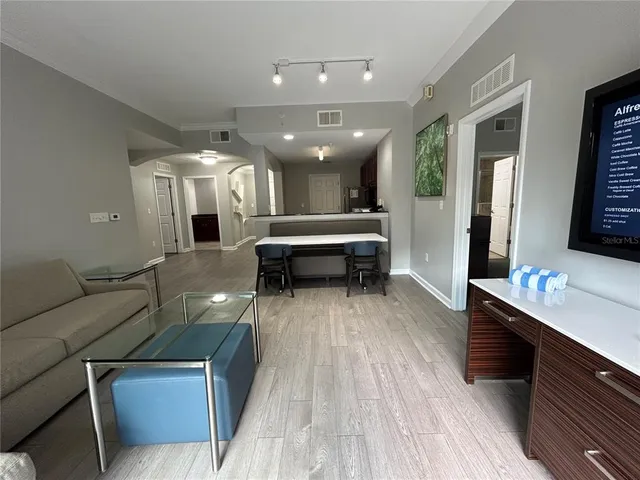 a spacious bathroom with a granite countertop sink and a toilet