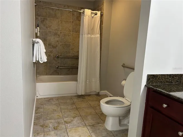 a bedroom with a bed and a large mirror